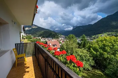 a balcony with flowers and a view of a town at Apartment Murata in Ortisei