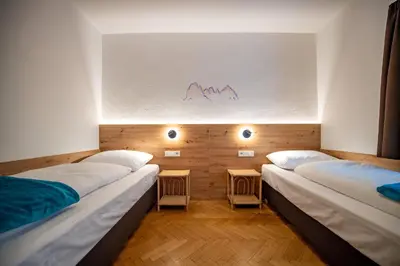 two beds in a room with a wall with a graph at Apartment Murata in Ortisei