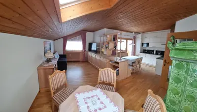 a kitchen and living room with a table and chairs at Schlernwohnung in Seis am Schlern in Siusi