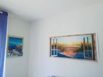two paintings are hanging on a wall at Casa di Max - private room in apartment with shared bathroom FREE PARKING in Bolzano