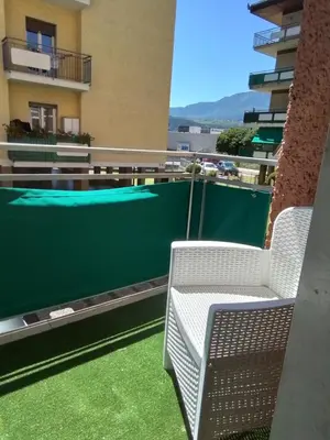 two chairs sitting on the balcony of a building at Casa di Max - private room in apartment with shared bathroom FREE PARKING in Bolzano