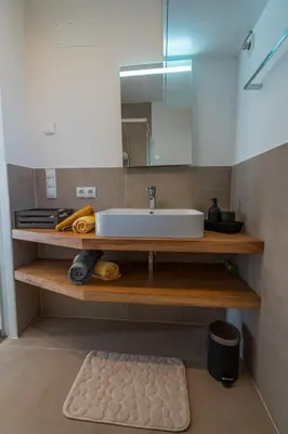 a bathroom with a sink and a mirror at Pia´s Bleibe in Caldaro