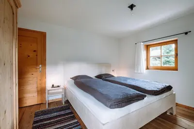 a bedroom with a large bed and a window at Mountain house Ebner in Selva dei Molini