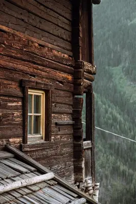 a window on the side of a log house with a view at Mountain house Ebner in Selva dei Molini