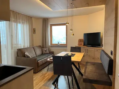 a living room with a couch and a table at A Sosta in Selva di Val Gardena