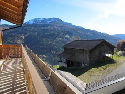a view of a building with a mountain in the background at Oeberst-hof in Sarntal