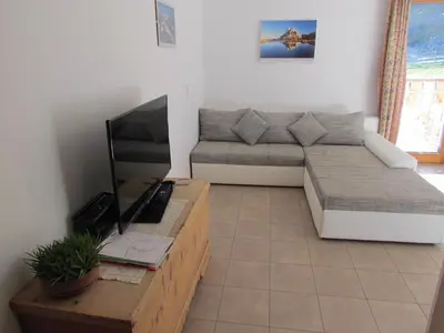 a living room with a couch and a tv at Oeberst-hof in Sarntal