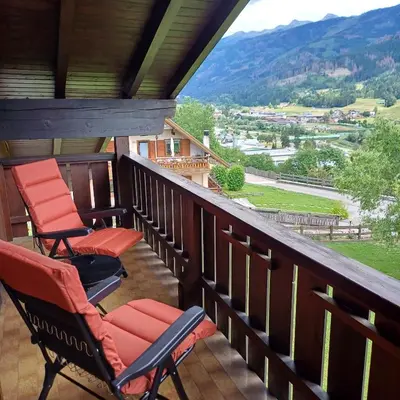 two chairs on a porch with a view of a mountain at Casa Luisa in Tesero