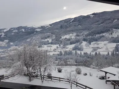 a view of a snow covered field with trees and mountains at Casa Luisa in Tesero