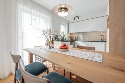 a dining room table with a bowl of fruit on it at BioTop Appartement Kronplatz in Perca