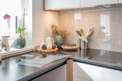 a kitchen counter with vases and flowers on it at BioTop Appartement Kronplatz in Perca