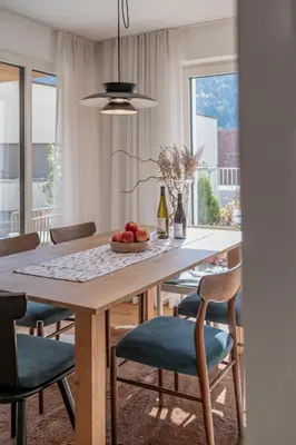 a dining room table with a bowl of fruit on it at BioTop Appartement Kronplatz in Perca