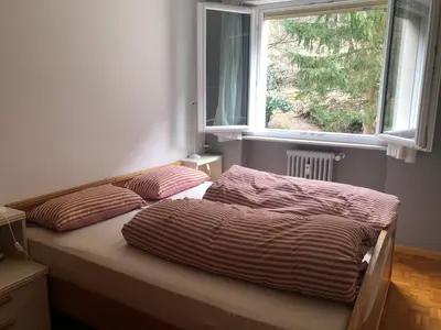 two beds in a bedroom with a window at Guesthouse Gigli 2 - Free Tourist Card & car parking - no trucks in Bolzano