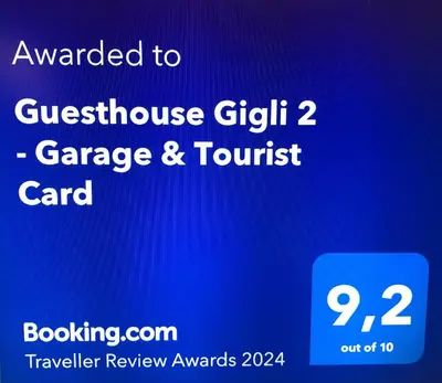 a blue sign with the text awarded to auchouse gilt garage at Guesthouse Gigli 2 - Free Tourist Card & car parking - no trucks in Bolzano
