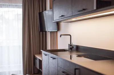a kitchen with a sink and a window at ROUDA luxury retreat am Kronplatz in Valdaora