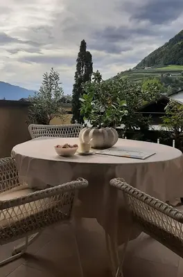 a white table with a bowl of food on it at LAnJA ihr besonderes Urlaubszuhause in Lagundo