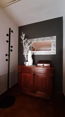 a room with a wooden dresser and a mirror at LAnJA ihr besonderes Urlaubszuhause in Lagundo