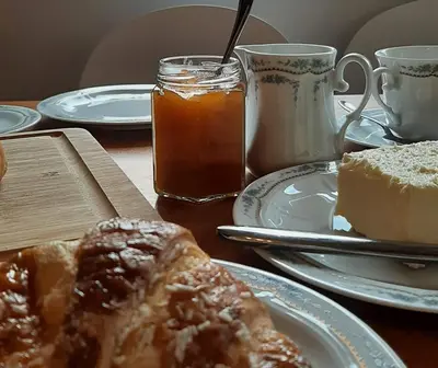a table topped with plates of food and drinks at LAnJA ihr besonderes Urlaubszuhause in Lagundo