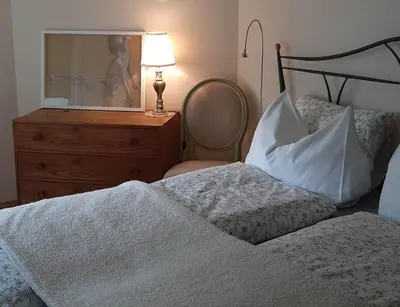 a bedroom with a bed and a dresser with a mirror at LAnJA ihr besonderes Urlaubszuhause in Lagundo