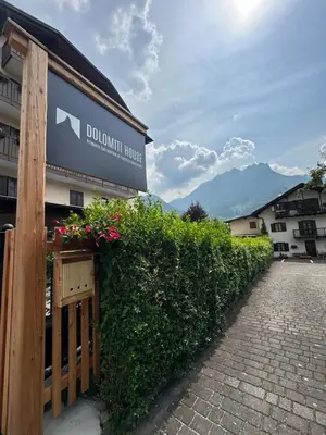 a building with a sign that reads doolin house at Dolomitihouse LARES in Fiera di Primiero