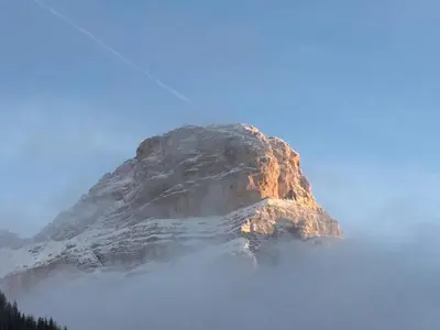 a mountain in the middle of a fog covered mountain at Piz Alpin B&B in Colfosco