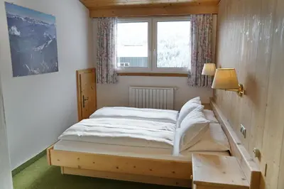 a small bedroom with a bed and a window at Piz Alpin B&B in Colfosco