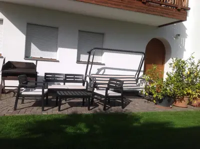 a group of chairs and a piano on a patio at Bbmarlene in Bolzano