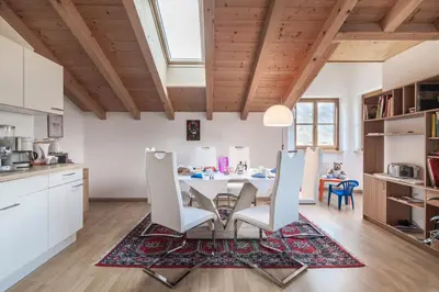 a kitchen and dining room with a table and chairs at Bbmarlene in Bolzano