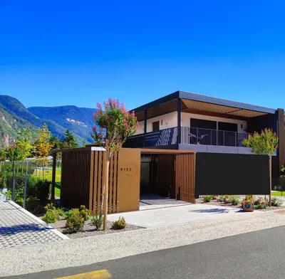 a house with a view of a mountain at Casa Grutzen Design Apartment with Pool in Bolzano in Bolzano