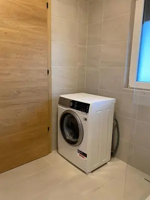 a washing machine in a room with a door at Casa Grutzen Design Apartment with Pool in Bolzano in Bolzano