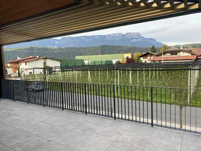 a balcony with a view of a mountain at Casa Grutzen Design Apartment with Pool in Bolzano in Bolzano