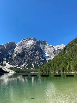 a mountain reflection in a lake in front of a mountain at Ameiserhof Guesthouse in Collalbo
