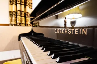 a black piano with the words cebelsteinin on it at Ameiserhof Guesthouse in Collalbo