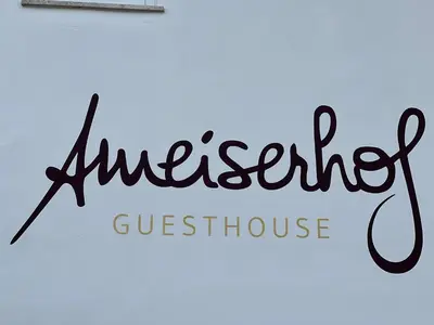 a sign for a grocery store with the words unexpected guest house at Ameiserhof Guesthouse in Collalbo