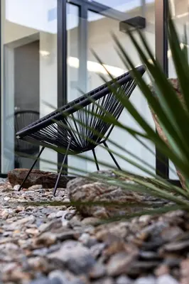 a black bench sitting in front of a building at Stay COOPER l CITY LOFT in Bolzano