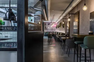 a restaurant with a row of tables and chairs at Stay COOPER l CITY LOFT in Bolzano