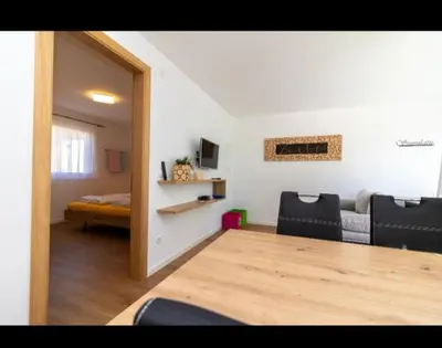 a living room with a table and a bed at SUNNLEITN HOF in Nova Ponente