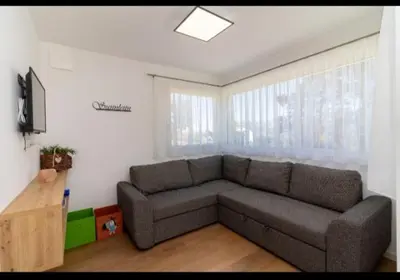 a living room with a couch and a tv at SUNNLEITN HOF in Nova Ponente