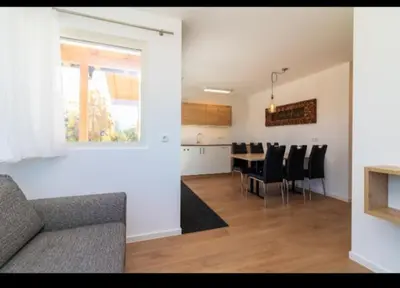 a living room and dining room with a table and chairs at SUNNLEITN HOF in Nova Ponente