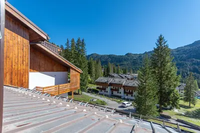 an aerial view of a building with a parking lot at Petit Arnica in Selva di Cadore