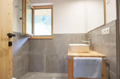 a bathroom with a sink and a window at Wolfhof_Ritten in Auna di Sopra