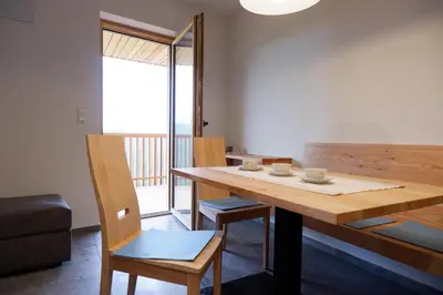 a dining room with a wooden table and chairs at Wolfhof_Ritten in Auna di Sopra