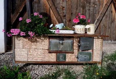 a wooden chest with flowers and pots on it at Wolfhof_Ritten in Auna di Sopra