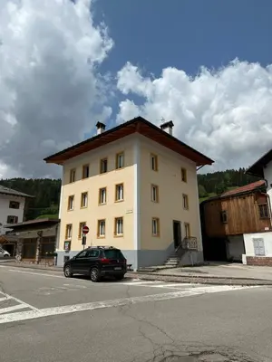 a building with a car parked in front of it at Casa Felice in Caviola