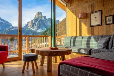a living room with a view of a mountain at Luxury Chalet Liosa - Ski in Ski out - Amazing view in Corvara in Badia