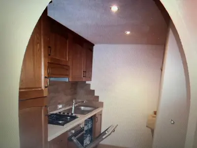 a kitchen with wooden cabinets and a sink at Appartaments Sanderhof in La Valle