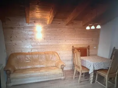 a living room with a couch and a table at Appartaments Sanderhof in La Valle