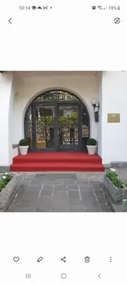 a large door with a red carpet in front of it at Pension an der Mayenburg in Vollan