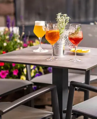 three wine glasses sitting on top of a table at Apartments Belaval in Santa Cristina in Val Gardena