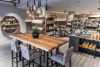 a restaurant with a wooden table and chairs at Apartments Belaval in Santa Cristina in Val Gardena